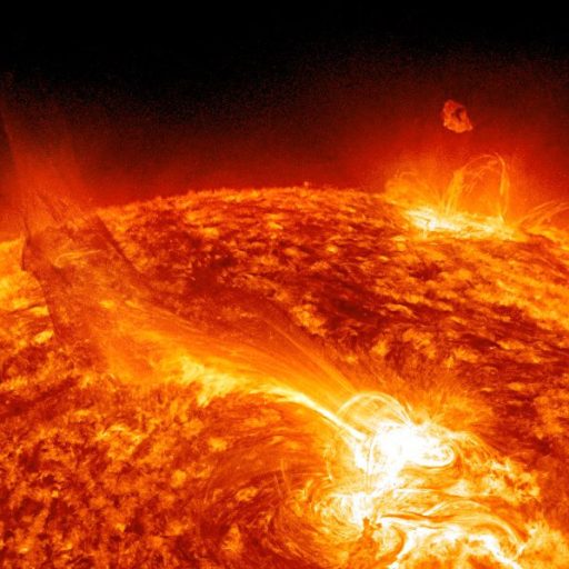 a close up of the sun with a black background showing a solar flare.