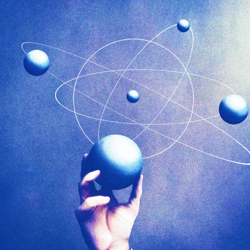 a hand is holding a ball with a model of the solar system.