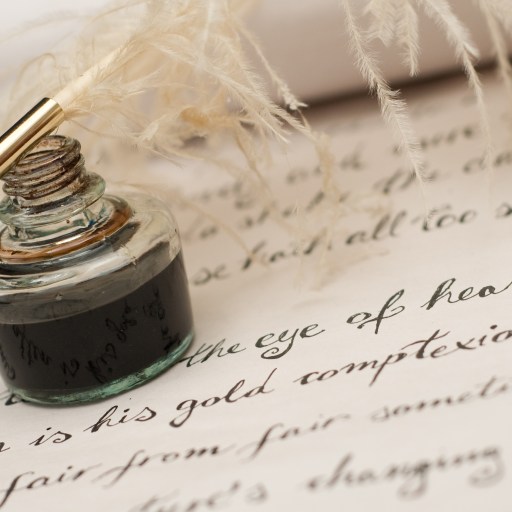 a fountain pen sitting on top of a piece of paper.