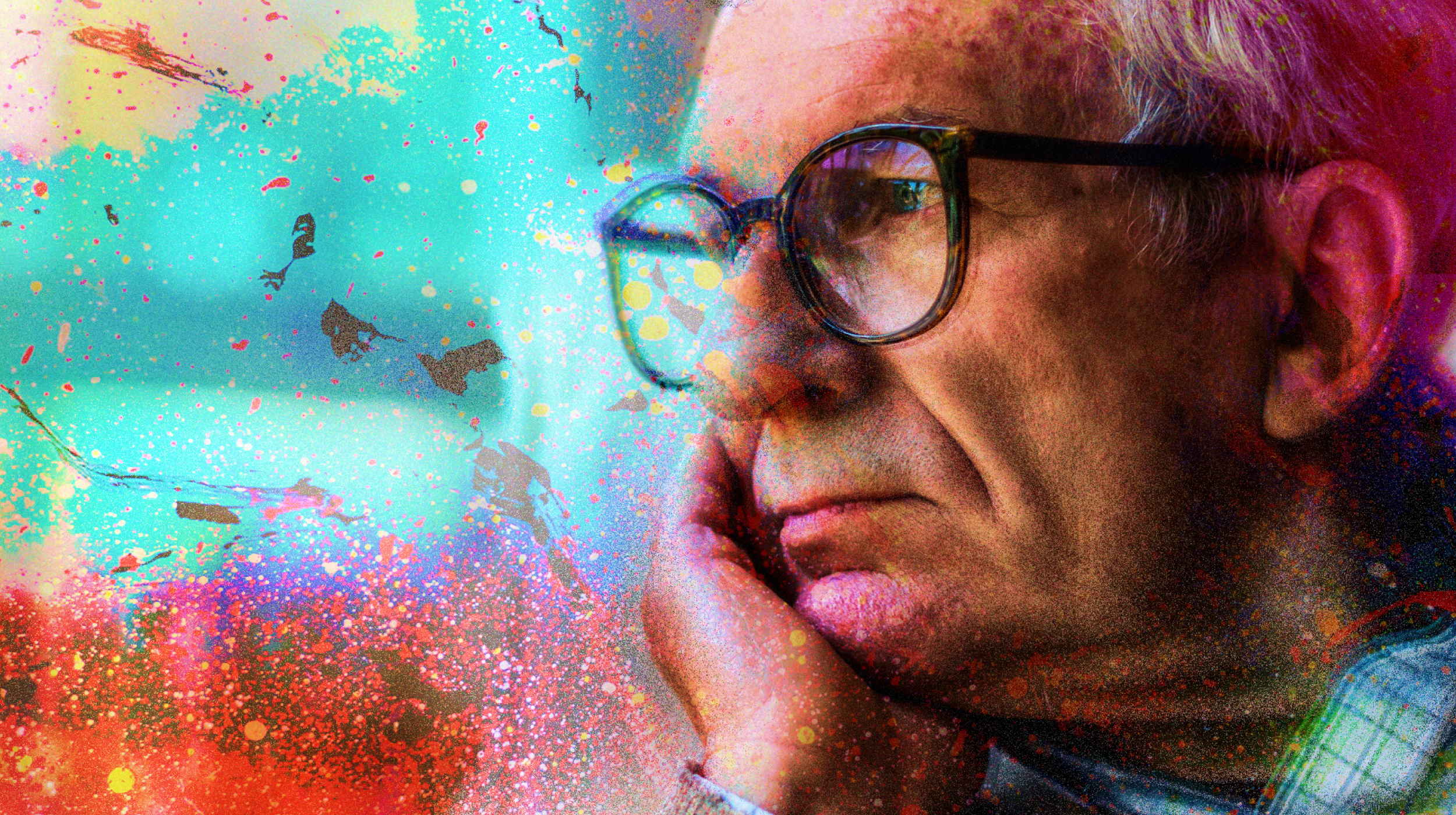 a man with glasses is looking out a window.