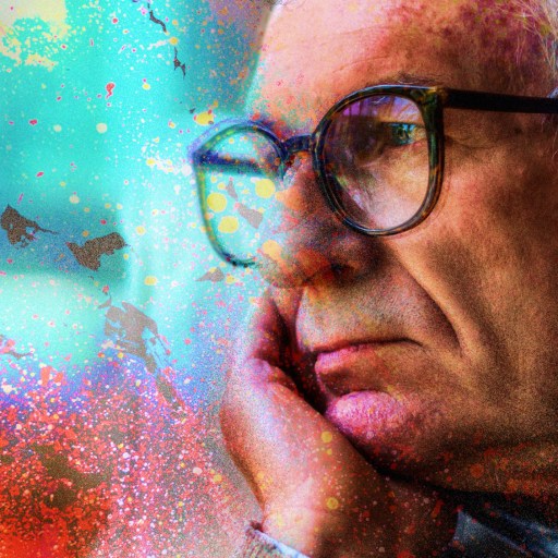 a man with glasses is looking out a window.