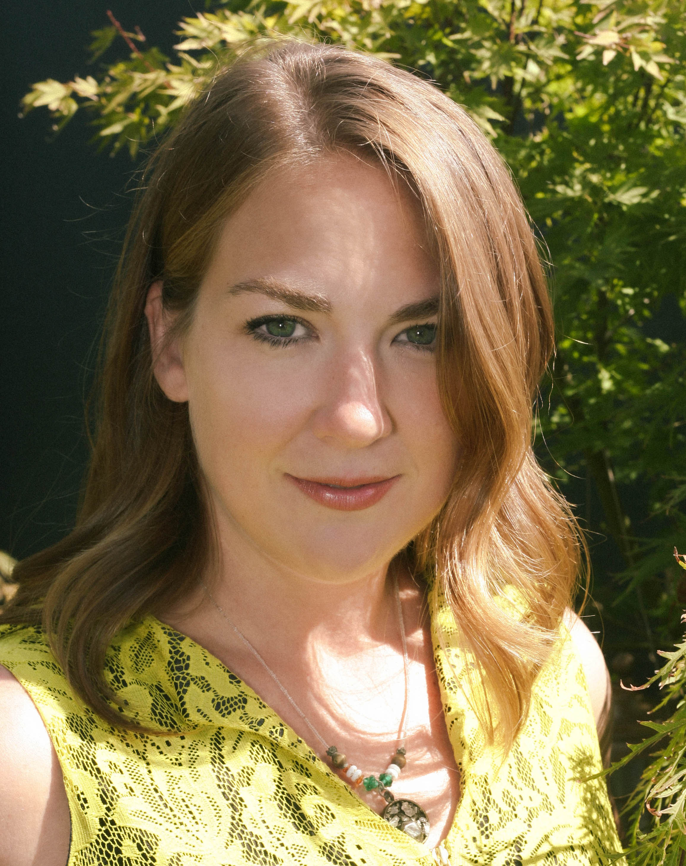 a close up of a person wearing a yellow shirt.