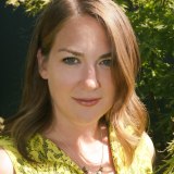 a close up of a person wearing a yellow shirt.