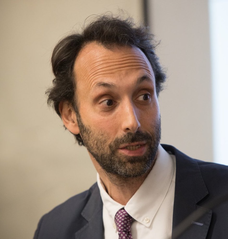 a man in a suit and tie looking off into the distance.