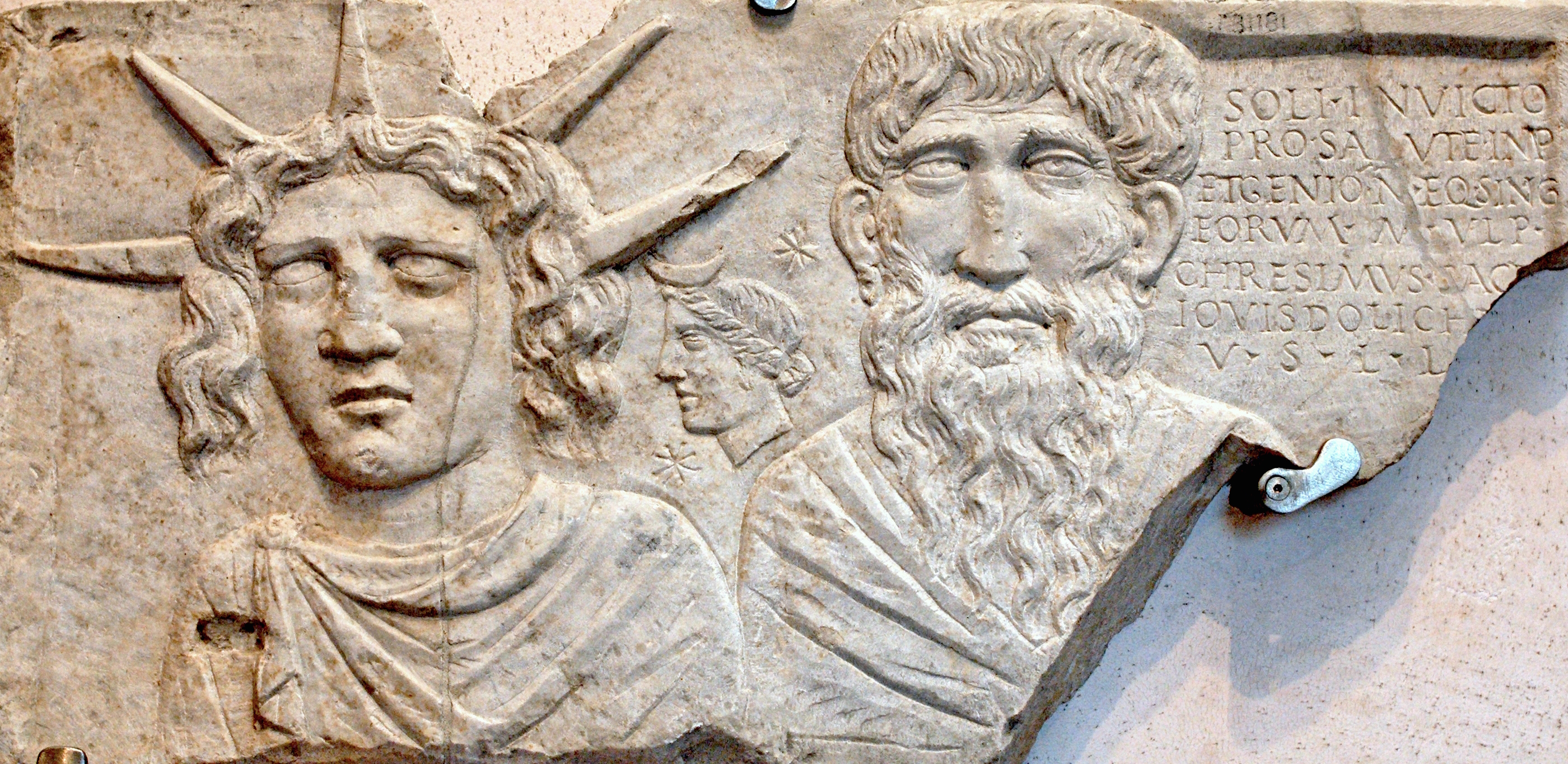 A close up of a carving on a wall showing Sol Invictus