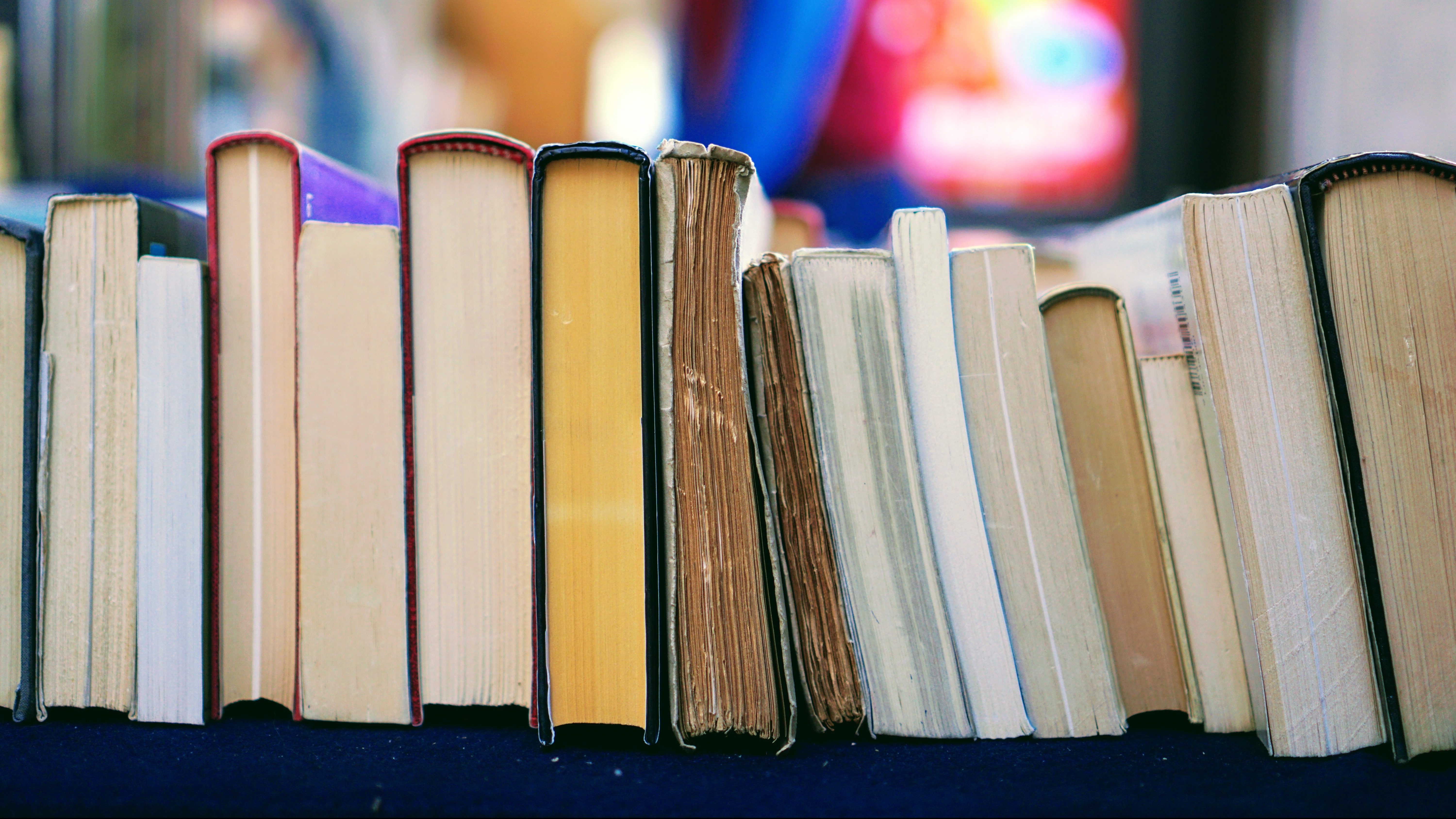 A row of books sitting on top of a table.