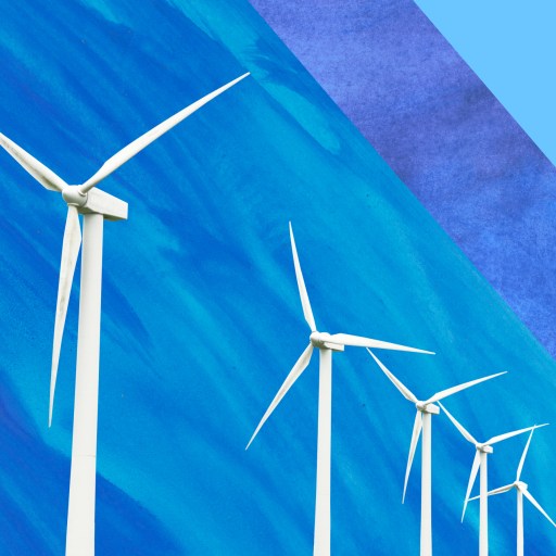 a row of wind turbines against a blue sky.