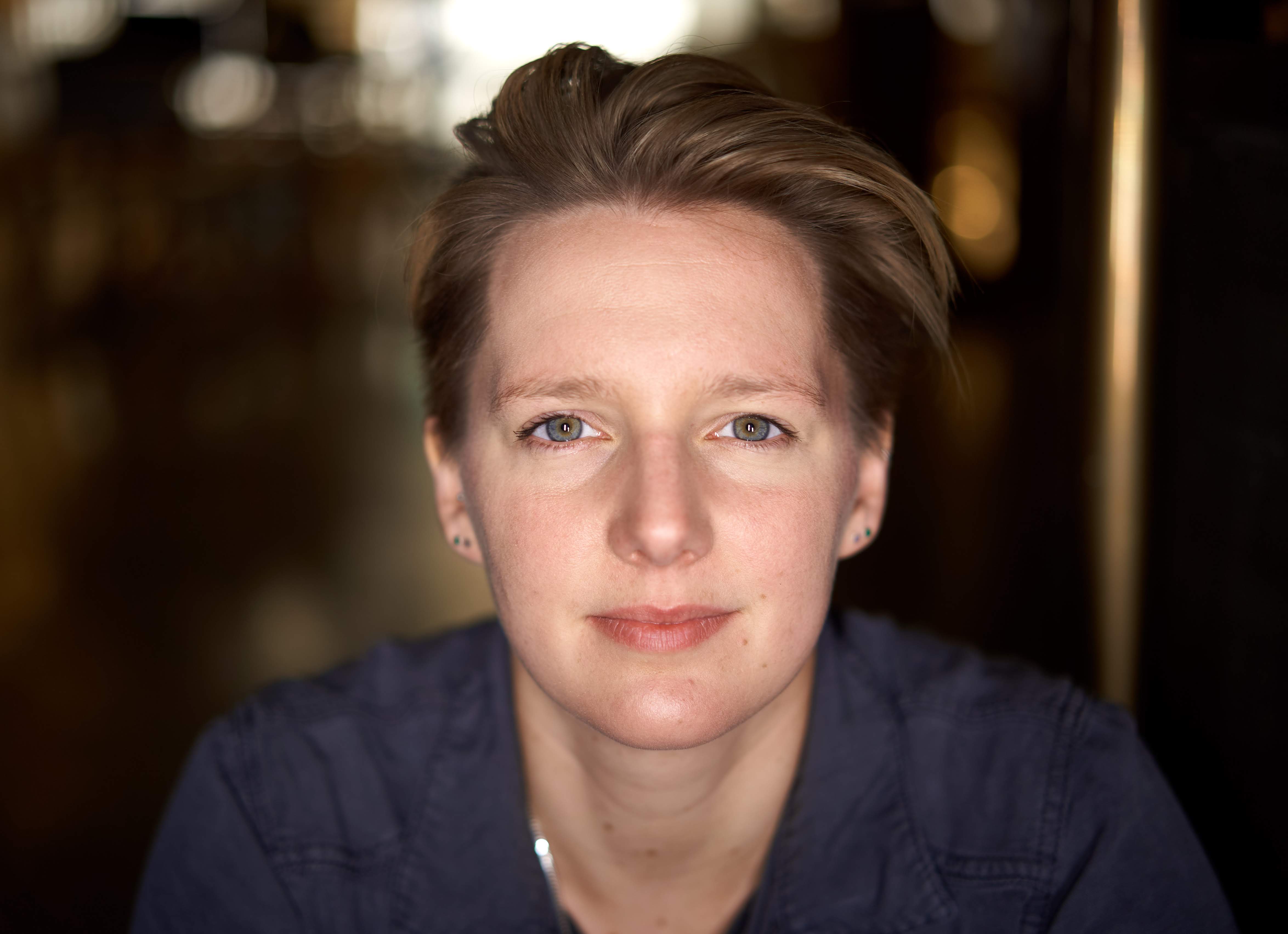 a close up of a person wearing a blue shirt.