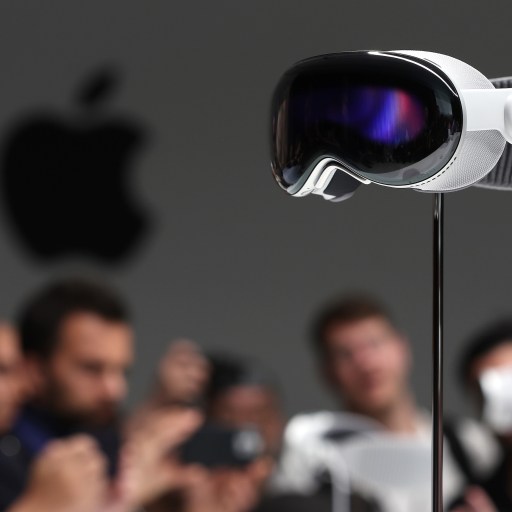 a group of people taking pictures of a projector.