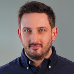 a close up of a person wearing a blue shirt.