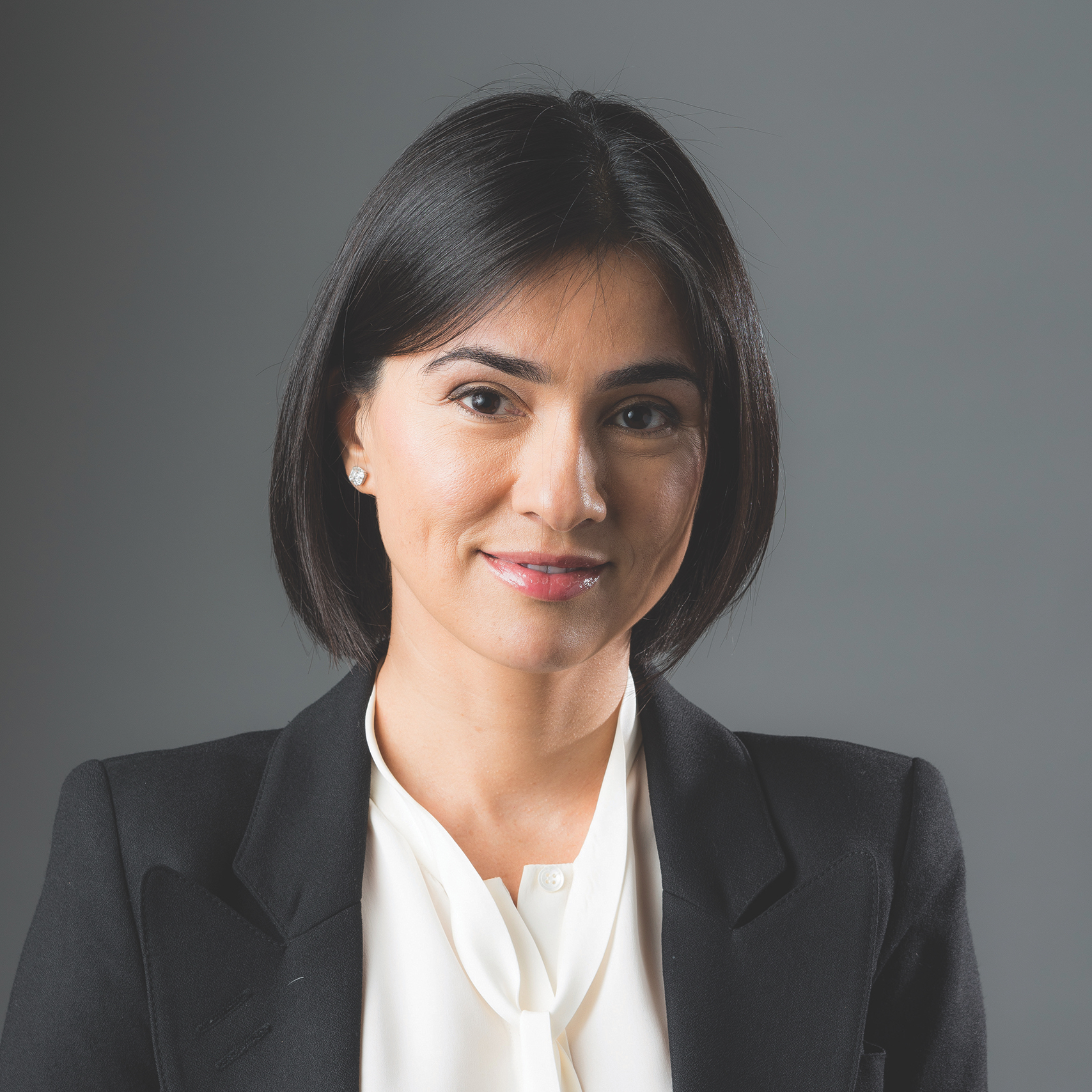 a woman wearing a black jacket and a white shirt.