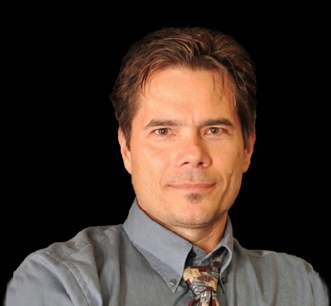 a man in a dress shirt and tie posing for a picture.
