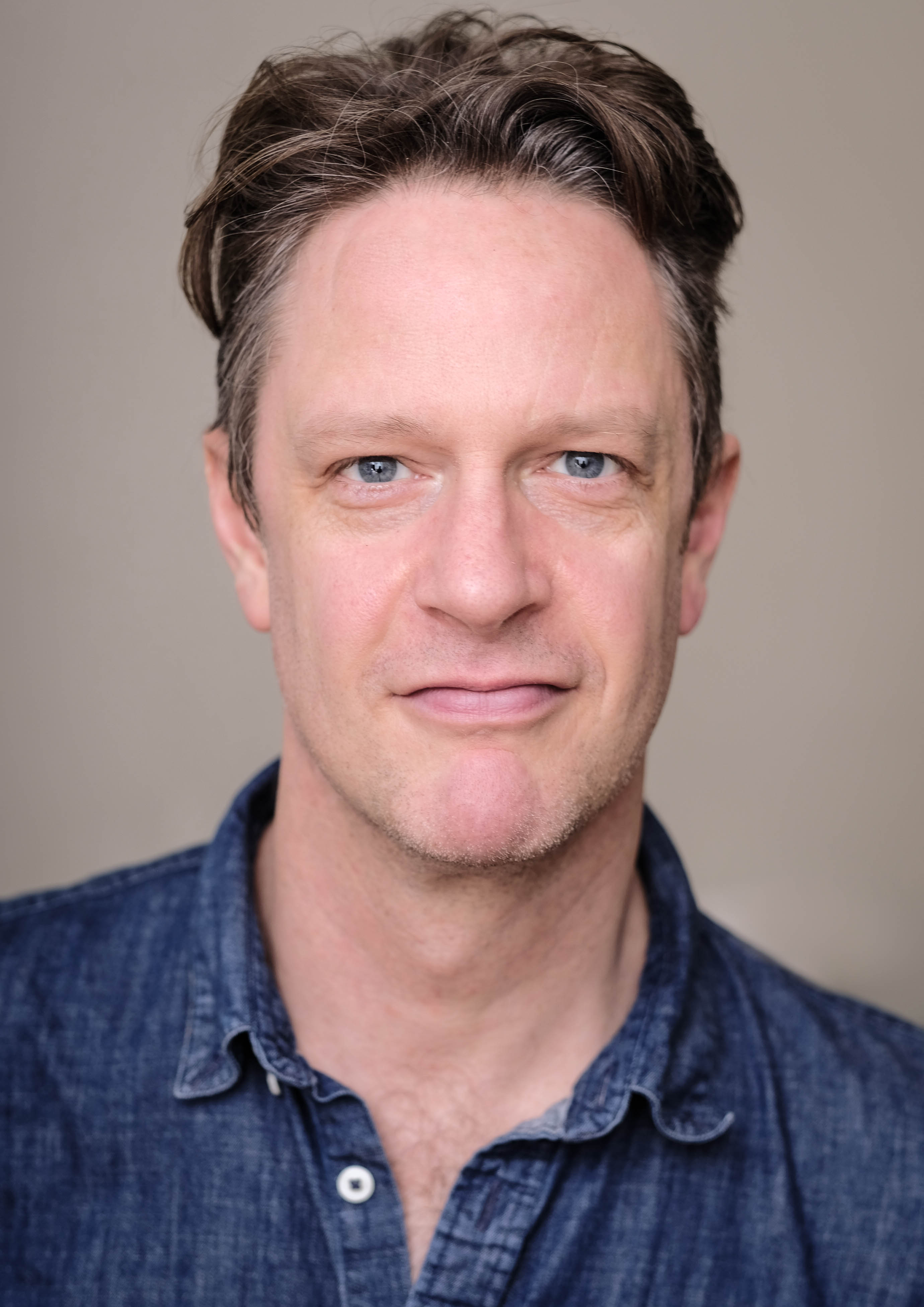 a close up of a person wearing a blue shirt.