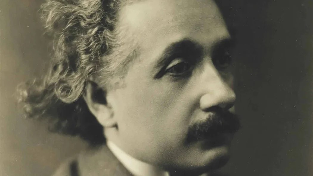 a black and white photo of a man with curly hair.