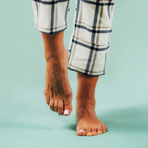 a person standing on a blue floor with their feet up.