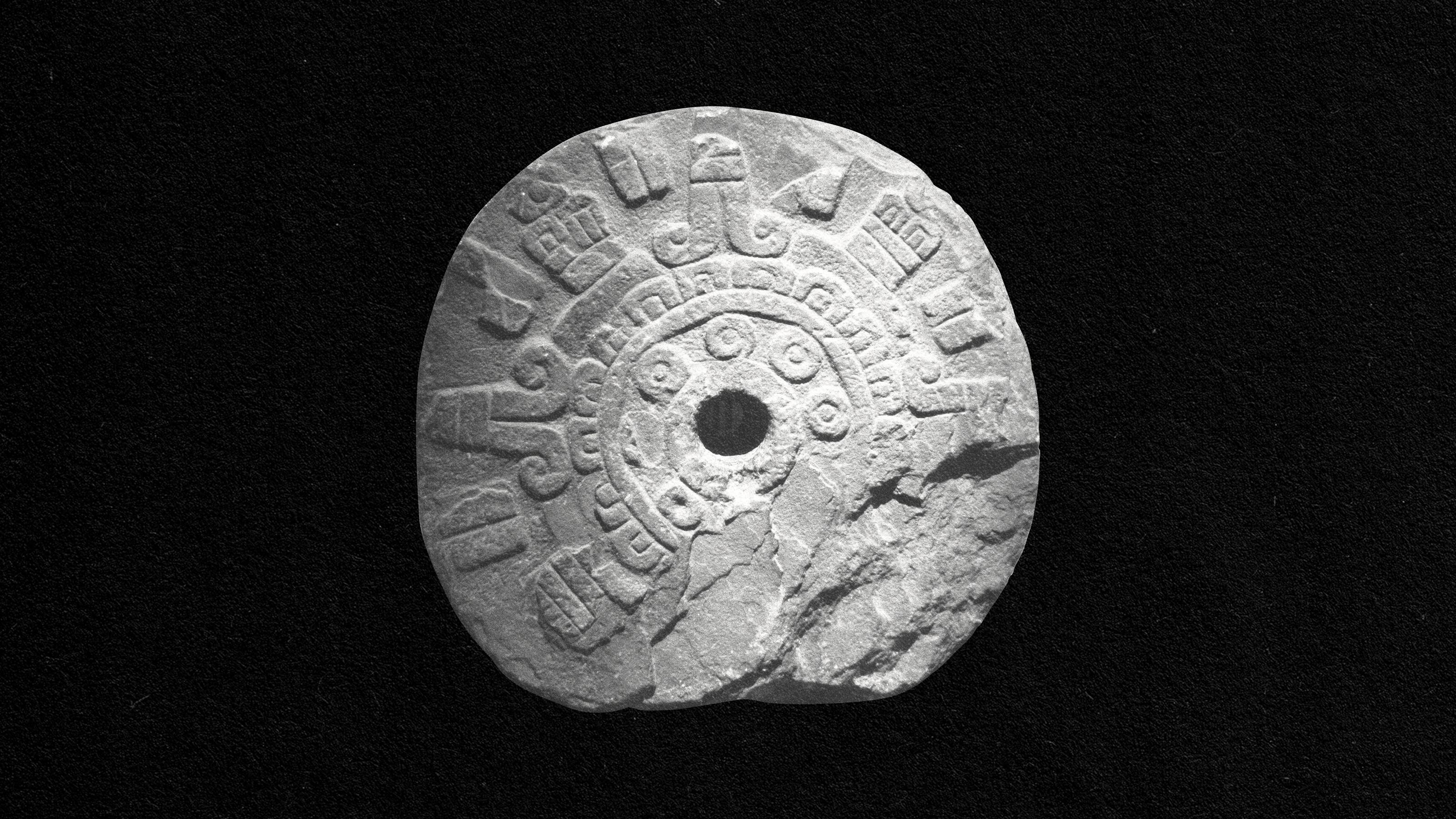 a stone wheel with a hole in it.