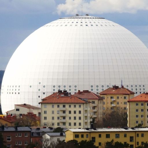 a large white dome in the middle of a city.