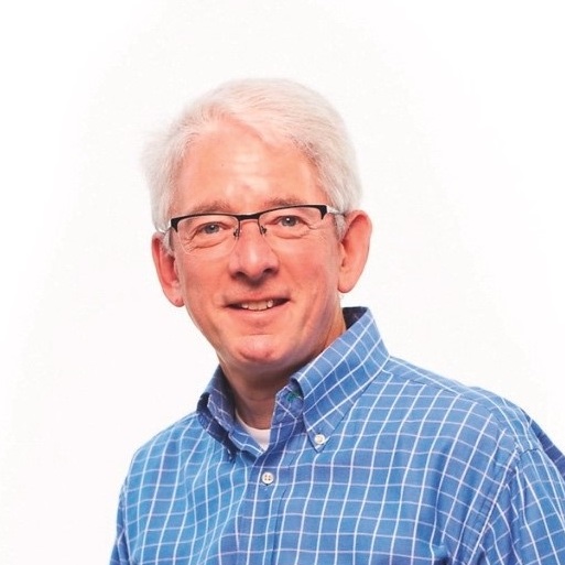 a man wearing glasses and a blue checkered shirt.