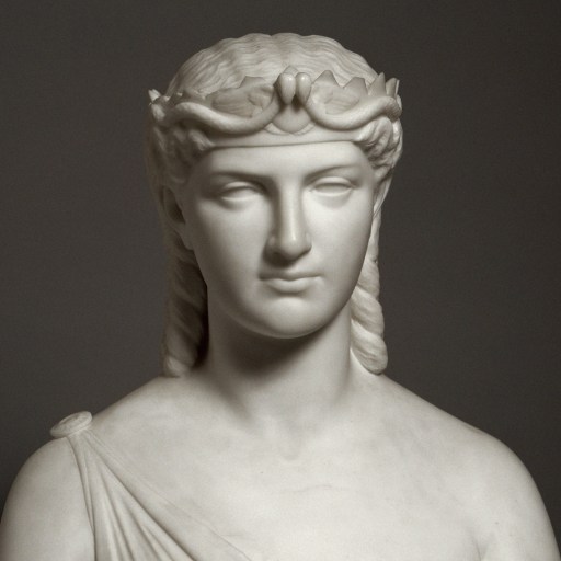 A bust of Cleopatra, the woman wearing a crown.