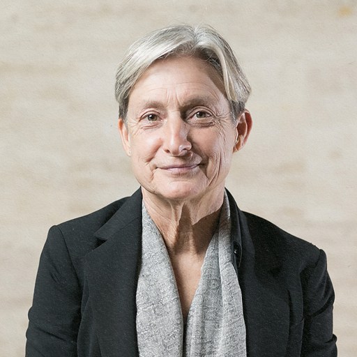 Judith Butler in a black jacket and grey scarf.
