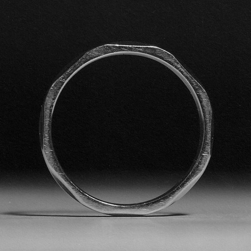 A monochromatic image capturing a silver ring.