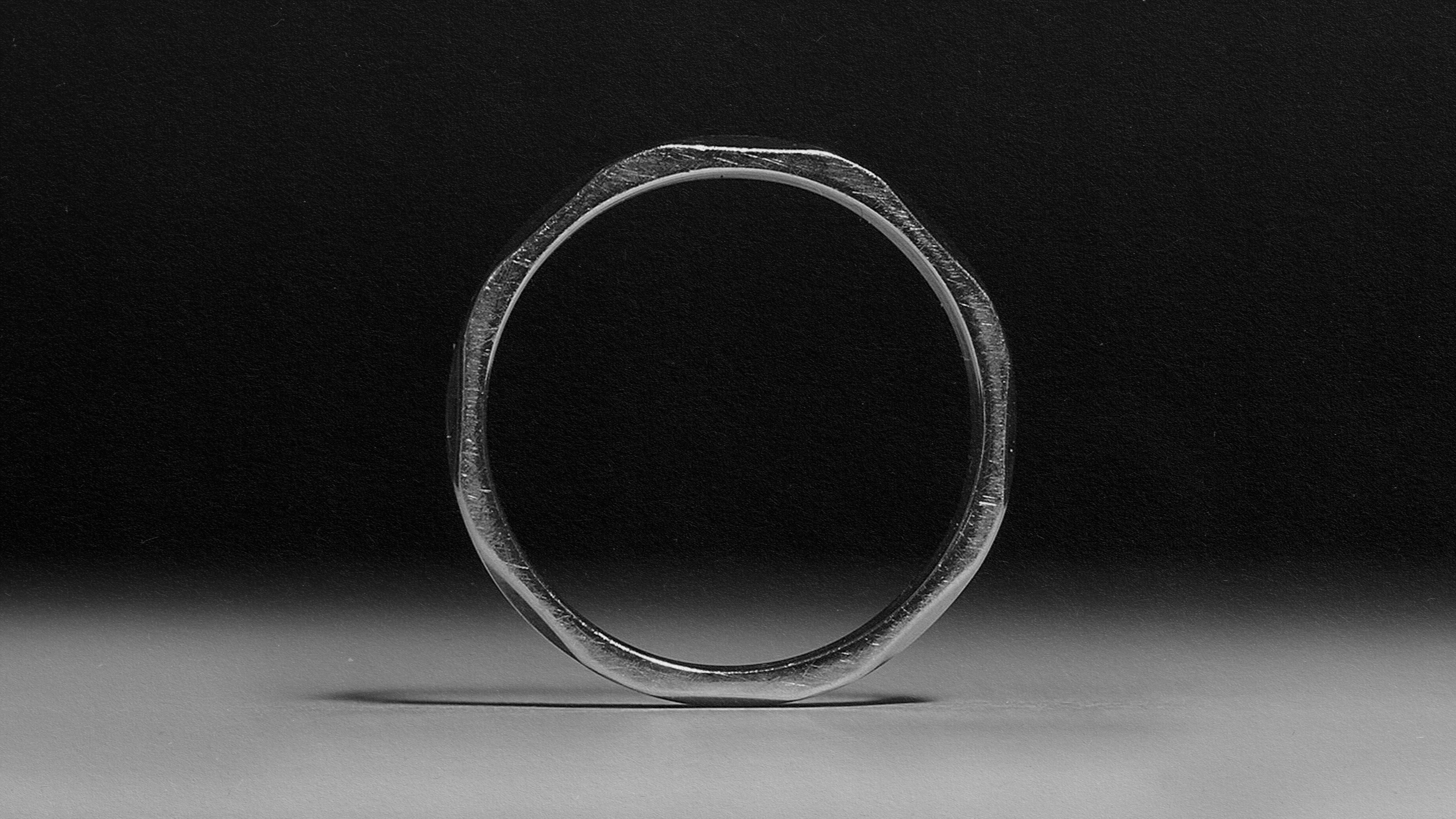 A monochromatic image capturing a silver ring.