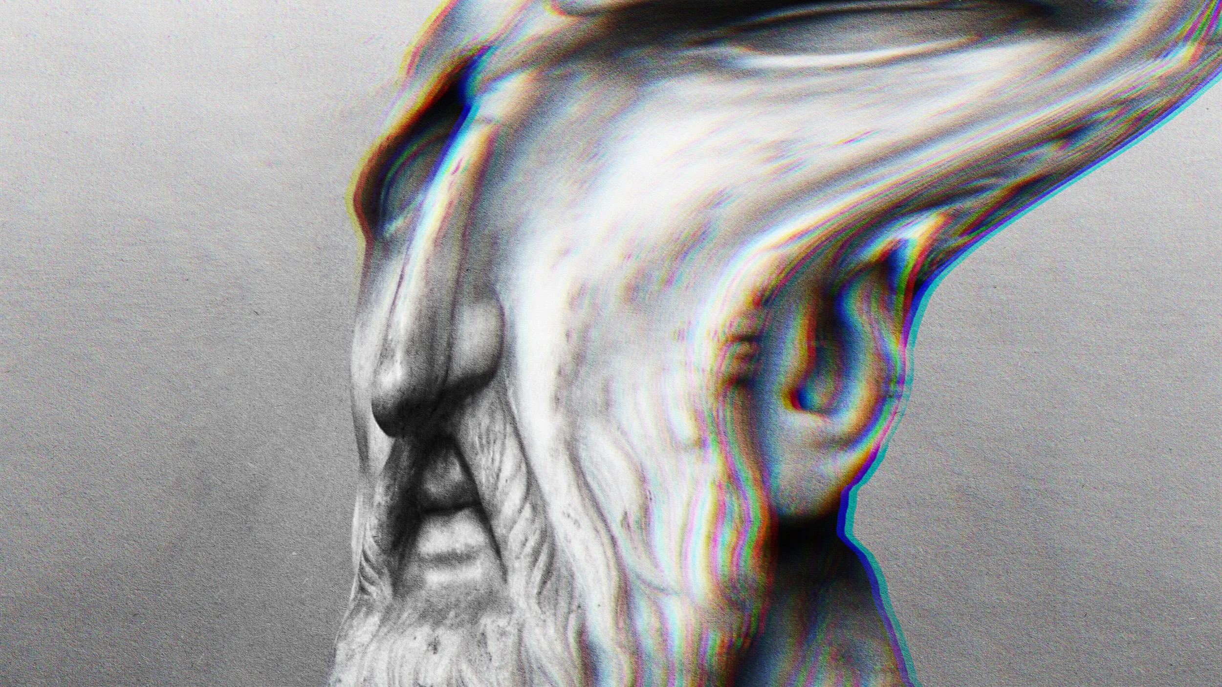 A stoic man with a beard in a black and white photo.