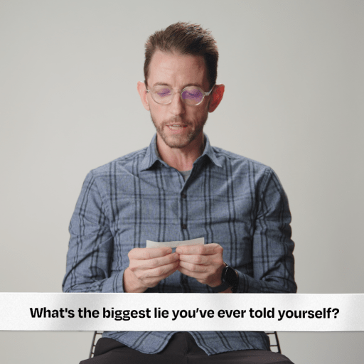 A man is sitting in front of a record player.