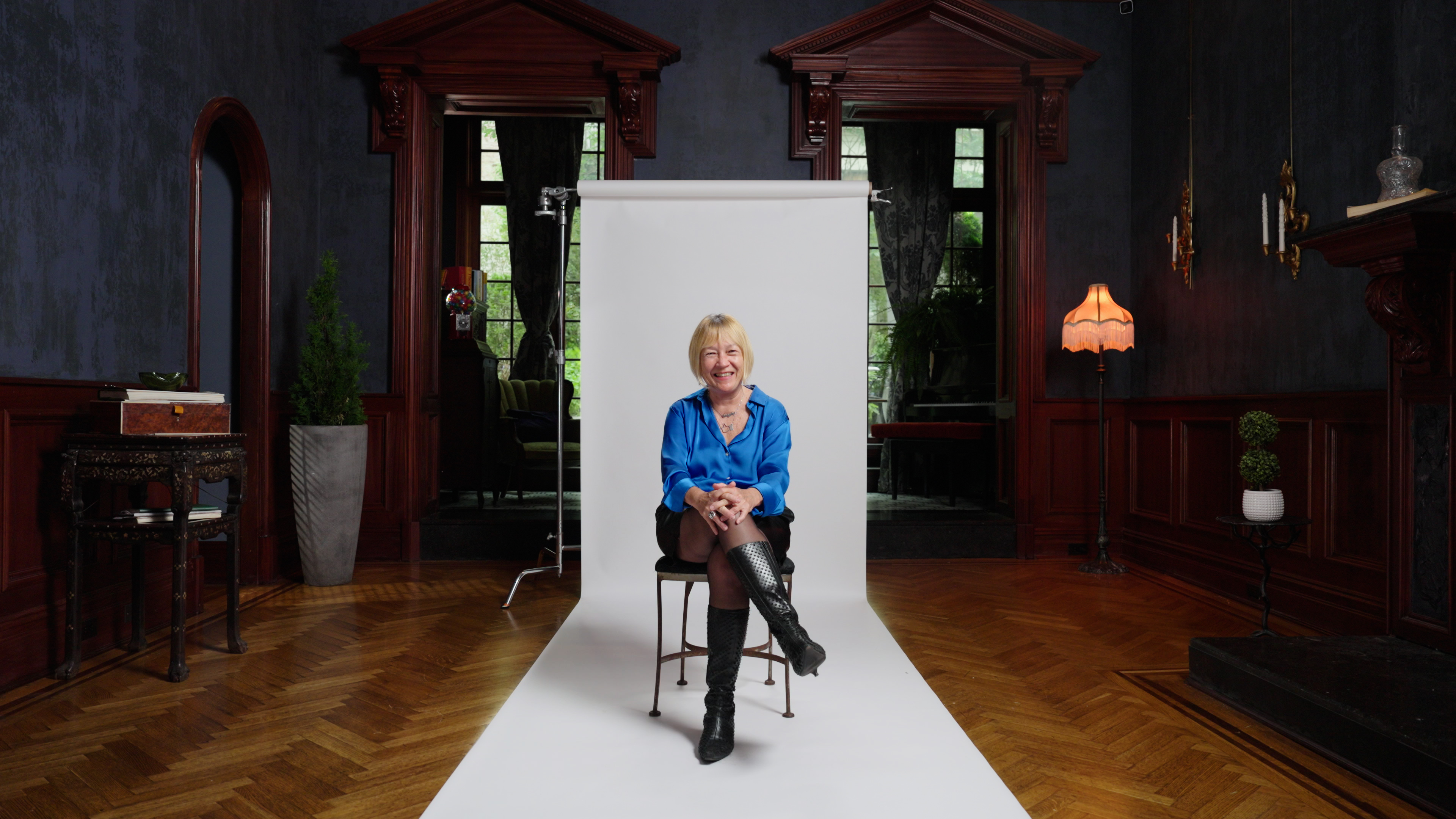 A woman sitting on a chair in a room.