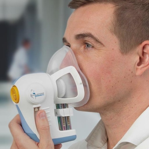 A man with liver disease is using a nebulizer in a hospital.