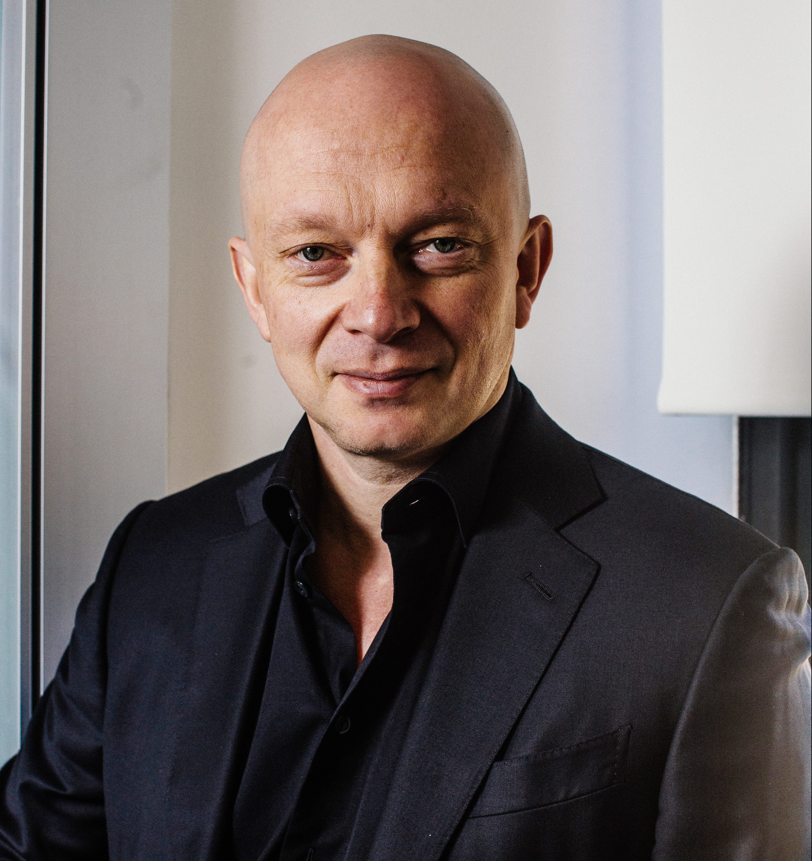 A man in a black suit.