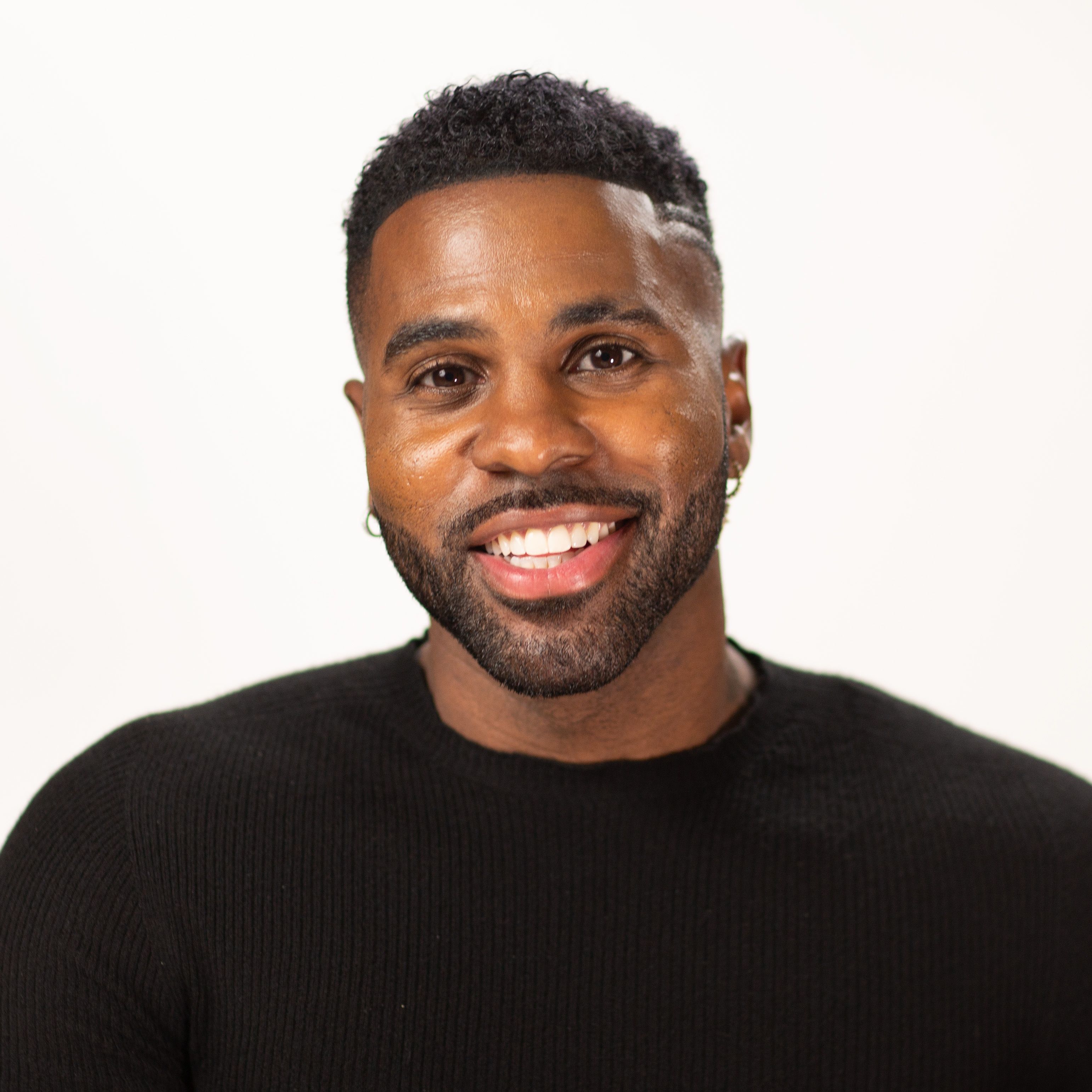 A black man smiling for the camera.