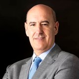 A bald man in a suit and tie.