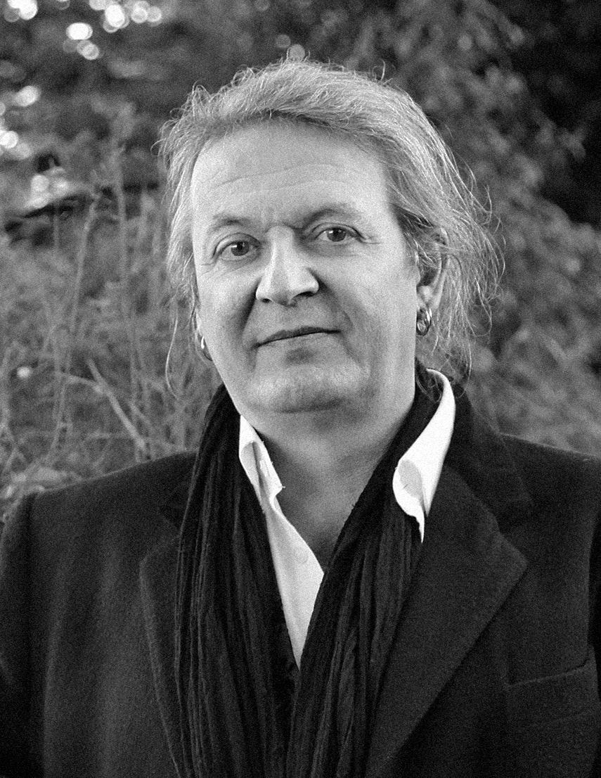 A black and white photo of a man wearing a scarf.