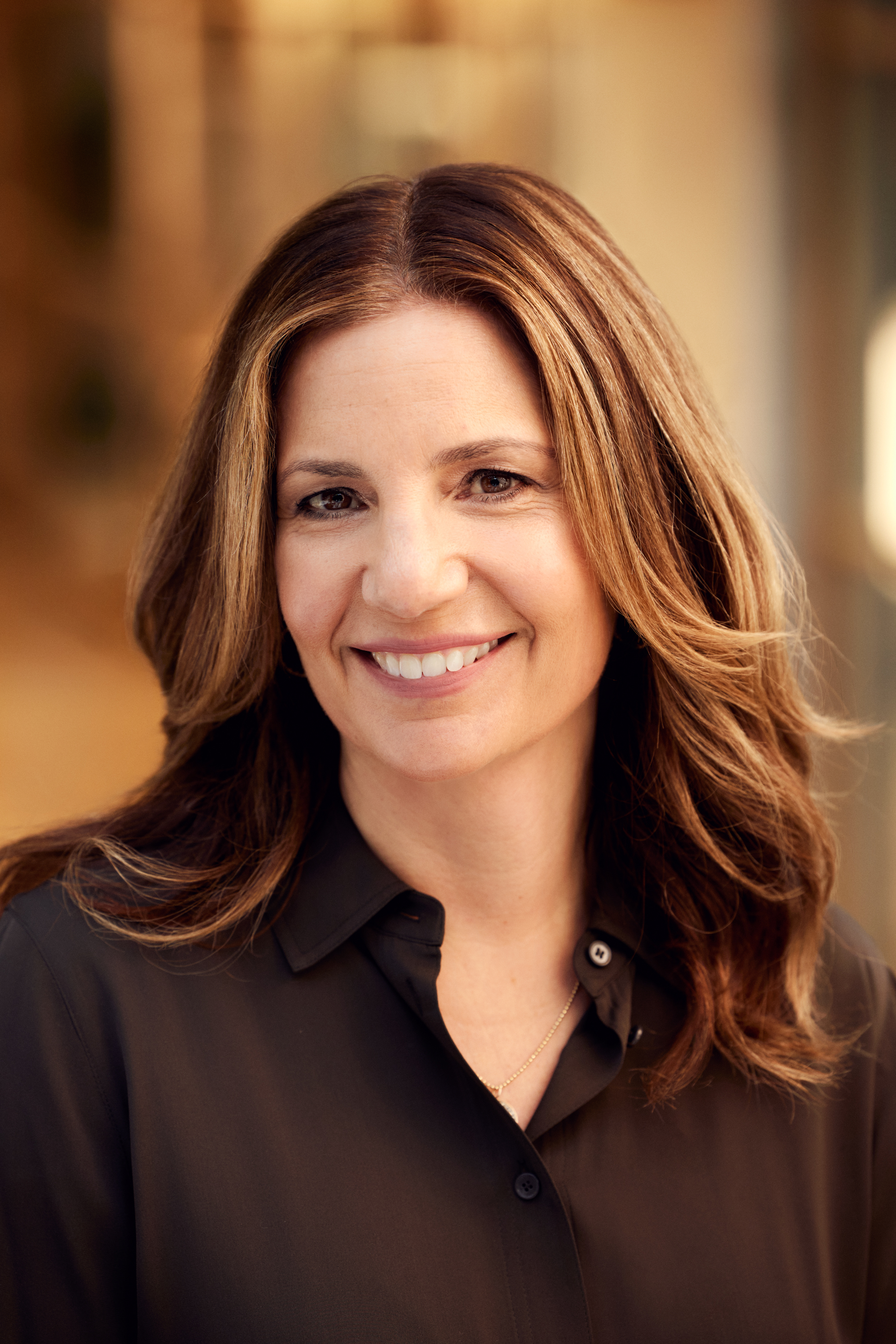 A smiling woman in a black shirt.