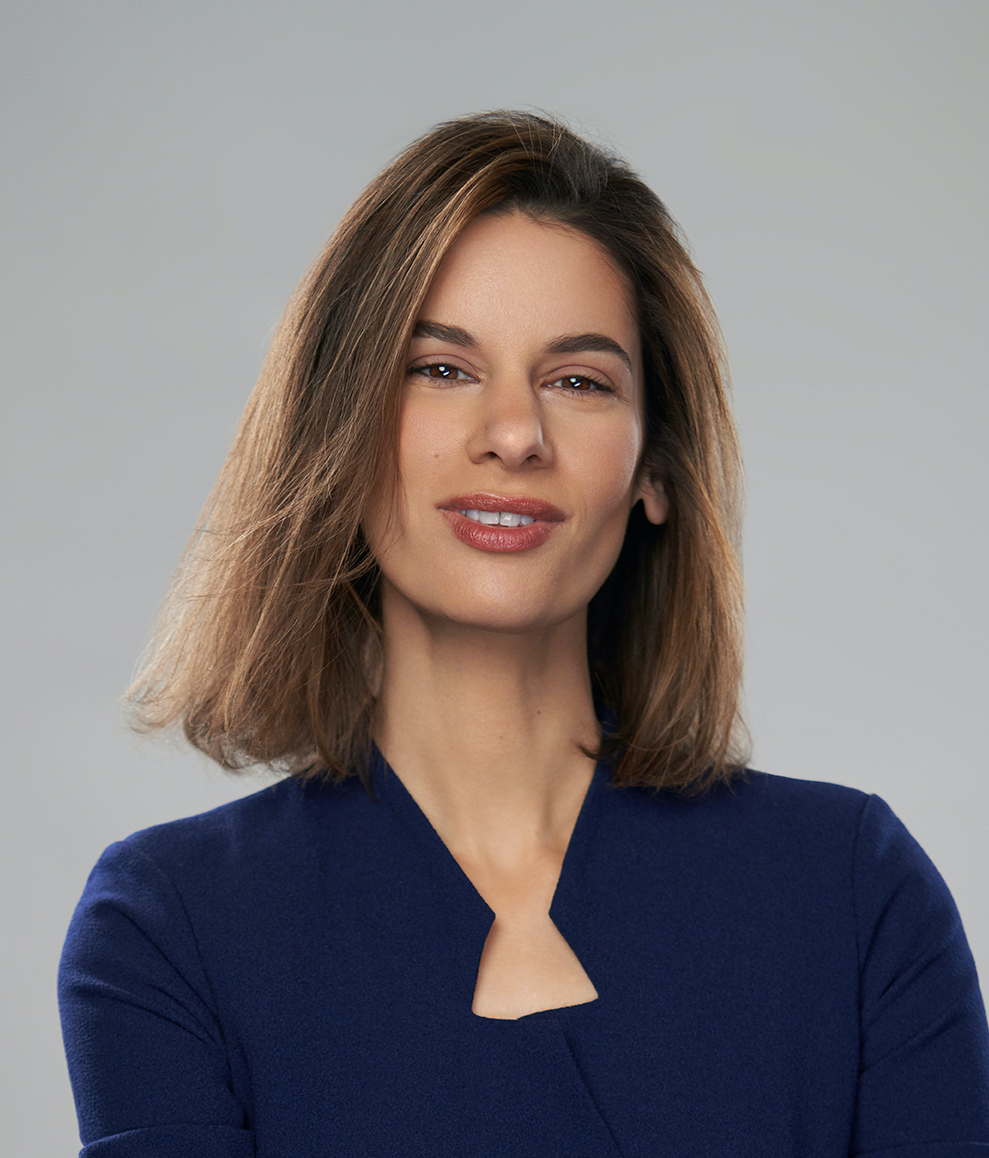 A woman in a blue shirt posing for a photo.