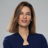 A woman in a blue shirt posing for a photo.