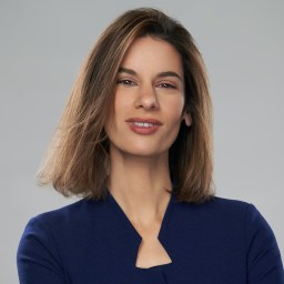 A woman in a blue shirt posing for a photo.