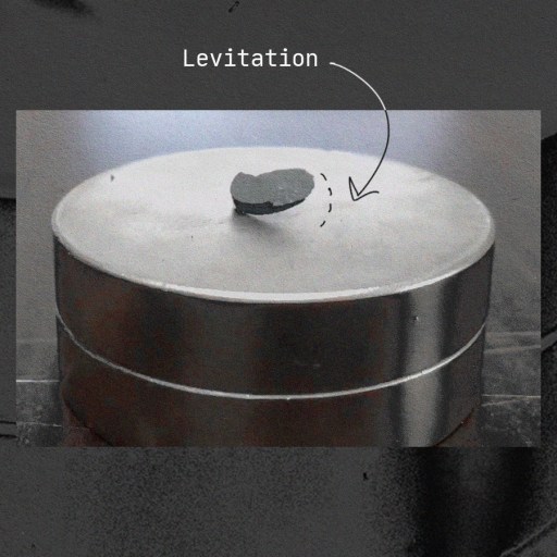 A black and white photo of a metal barrel with an lk-99 arrow pointing to it.