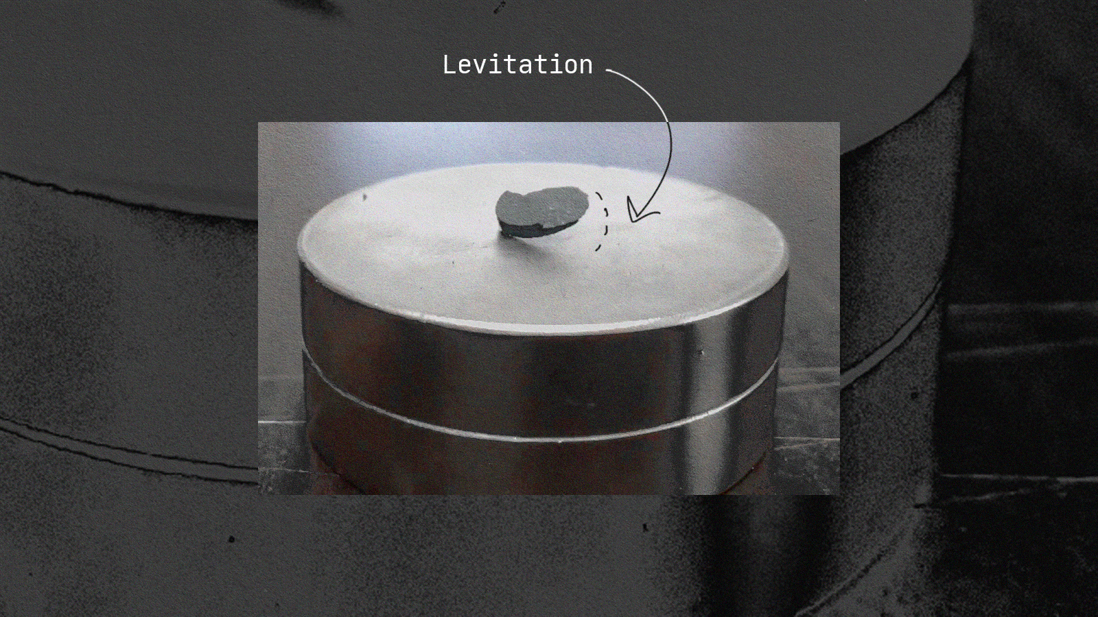 A black and white photo of a metal barrel with an lk-99 arrow pointing to it.