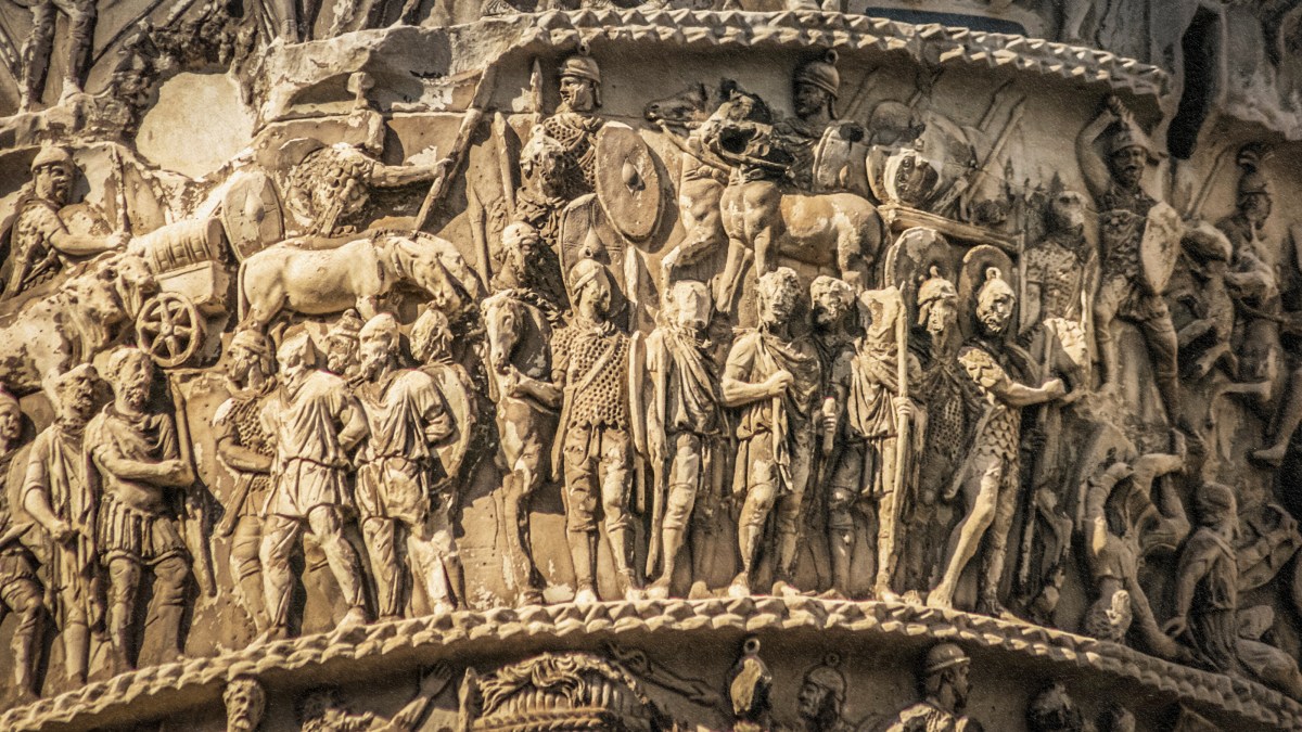 A statue of a man on a column, reflecting the history of pants.
