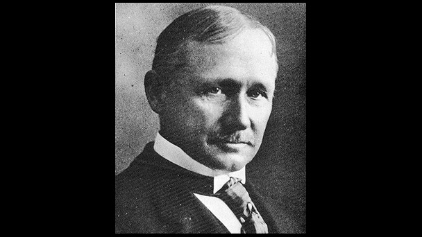 An old photo of a man in a suit and tie.
