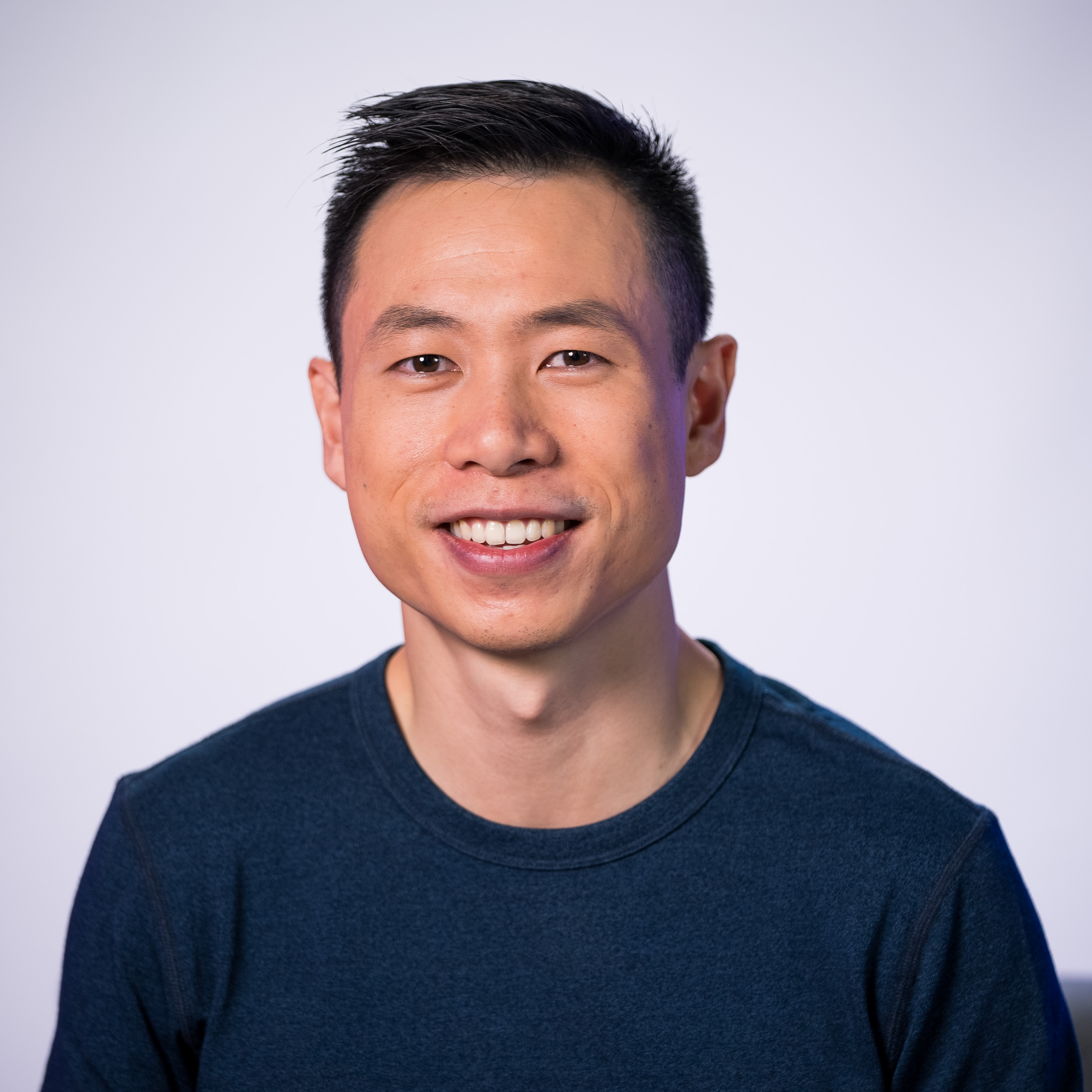 A smiling man in a blue shirt.