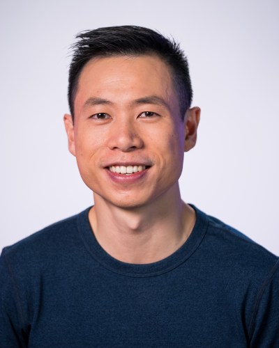 A smiling man in a blue shirt.