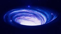 A swirling, bright galaxy or nebula in deep space with a luminous center and spiraling blue and purple hues against a dark starry background.