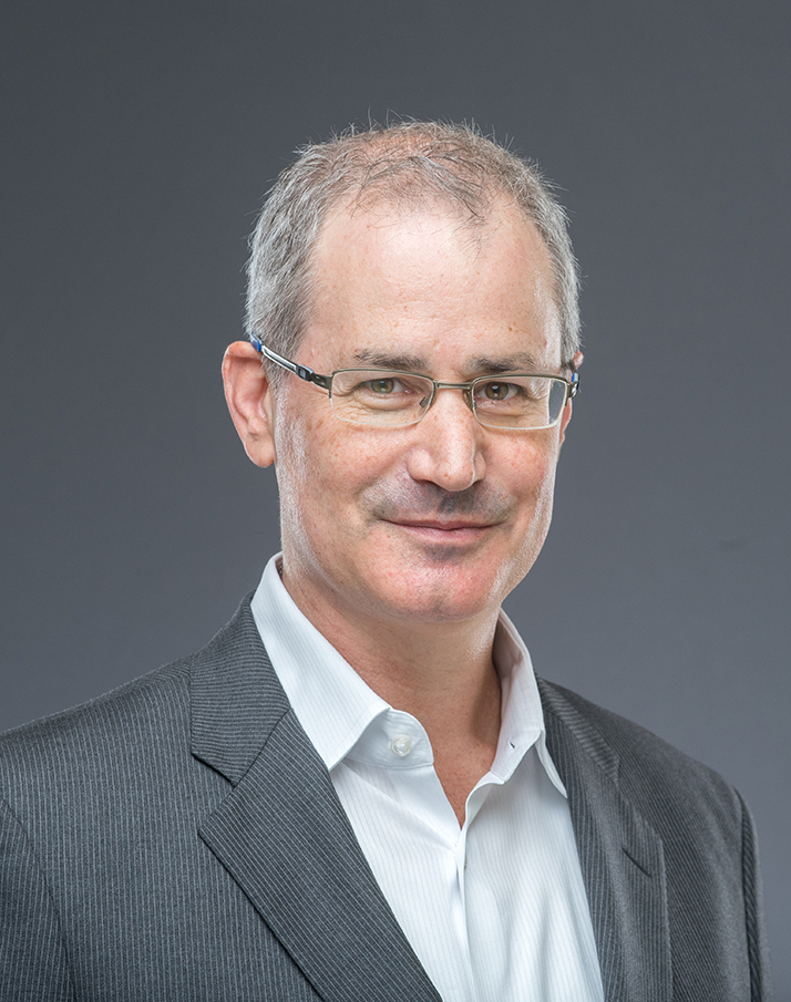 A man in glasses is posing for a photo.