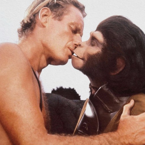 A man and a monkey named Ivanov kissing in the ocean.