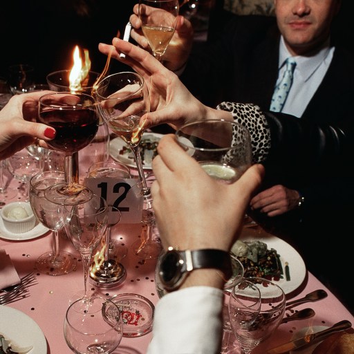 A group of people engaging in sobremesa at a table.
