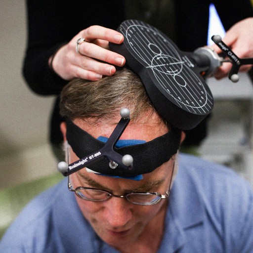 A man is undergoing a TMS treatment for depression.