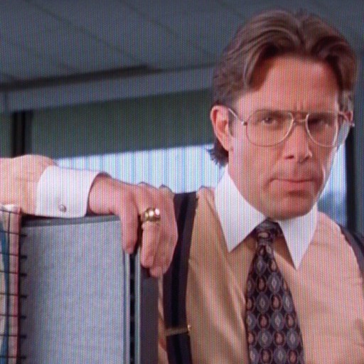 A man in a tie and suspends holding a crate.